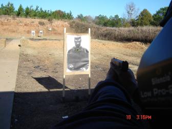 Police Officer going over range exercises with Superior Security Concepts staff