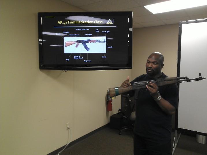 Instructor Leon S. Adams demonstrating the Colt carbine for home defense